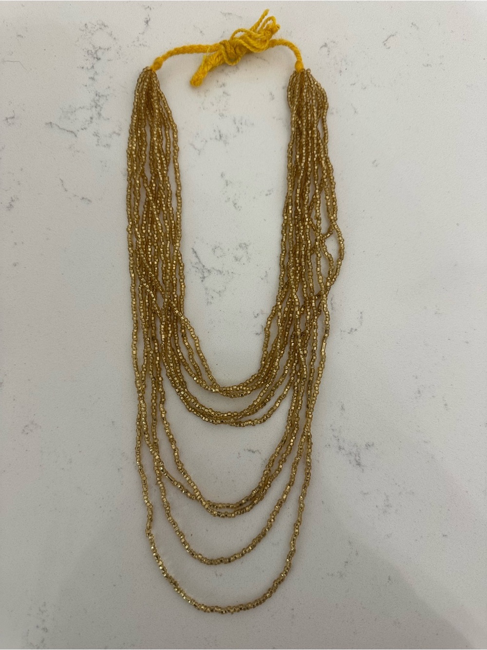 Strands of Ecuadorian gold beads for crafting traditional Walka necklaces  🇪🇨